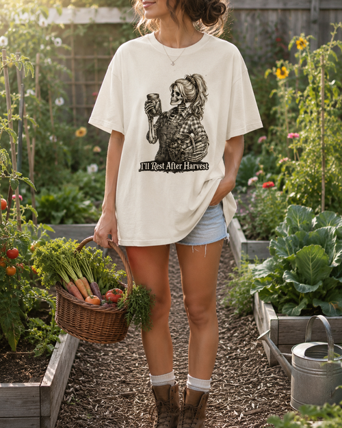 Person/skeleton standing in a garden holding a basket of vegetables, wearing a white t-shirt with a graphic design.